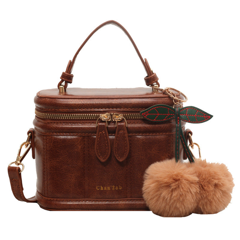 Bolsa tipo cubo con textura portátil y popular.